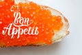 Appetizing red caviar sandwich and bon appeit lettering phrase