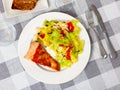 Appetizing roasted salmon steak with a light vegetable salad made from tomatoes Royalty Free Stock Photo