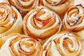 Appetizing ruddy buns-roses with apple slices. Background