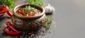 Appetizing salsa made from fresh tomatoes, peppers, onions and cilantro with garlic in clay bowl on gray background Royalty Free Stock Photo