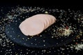 Appetizing sausage sliced on a slate board on a black background with spices and chilli selective artistic focus