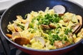 Appetizing seafood pasta with vongole and fried shrimps in a pan