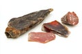 Appetizing selection of cured meats showcasing textures and colors on a clean white background Royalty Free Stock Photo