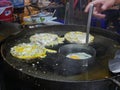 Appetizing sizzling oyster omelette Hoy Tod being cooked on a hot pan at night, Chiang Mai, Thailand - Thai delicious street