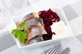 Slightly salted herring with grated beets, greens and mayonnaise