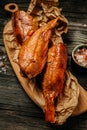 Appetizing smoked fish on the kitchen board. river bass fish on wooden cutting board. delicious snacks for beer