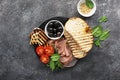 Appetizing snack with fried cheese haloumi, olives, bruschetta, tomatoes, olives, pine nuts, olive oil, honey and Royalty Free Stock Photo