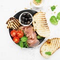 Appetizing snack with fried cheese haloumi, olives, bruschetta, tomatoes, olives, pine nuts, olive oil, honey and Royalty Free Stock Photo