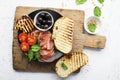 Appetizing snack with fried cheese haloumi, olives, bruschetta, tomatoes, olives, pine nuts, olive oil, honey and Royalty Free Stock Photo
