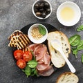 Appetizing snack with fried cheese haloumi, olives, bruschetta, tomatoes, olives, pine nuts, olive oil, honey and Royalty Free Stock Photo