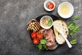 Appetizing snack with fried cheese haloumi, olives, bruschetta, tomatoes, olives, pine nuts, olive oil, honey and Royalty Free Stock Photo