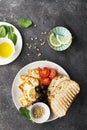 Appetizing snack with fried cheese haloumi, olives, bruschetta, tomatoes, olives, pine nuts, olive oil, honey and Royalty Free Stock Photo