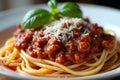 An appetizing spaghetti bolognese dish with fresh basil and parmesan a culinary art in diffused ambient light Royalty Free Stock Photo