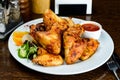 Appetizing spicy baked chicken wings with sweet chili sauce on t