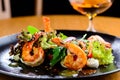 Appetizing spicy salad with shrimps, radish and sauce on the tab