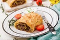 Appetizing strudel with minced beef, onions Royalty Free Stock Photo