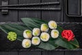 Appetizing sushi maki roll on a black stone plate