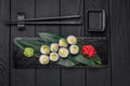 Appetizing sushi maki roll on a black stone plate