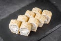 Appetizing sushi roll with Philadelphia tofu sesame cheese on a black stone plate