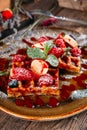 Dessert Belgian waffles with berries and sauce