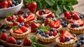 Appetizing tartlets cream, strawberries, blueberries mint sweet