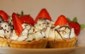 Appetizing tartlets with whipped cream and strawberries. Cream, Royalty Free Stock Photo