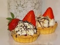 Appetizing tartlets with whipped cream and strawberries. Cream, Royalty Free Stock Photo