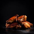 Appetizing tasty hot grilled chicken wings, isolated on black close-up,