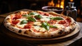 appetizing and tasty typical Italian pizza with mozzarella, cherry tomatoes and basil cooked in a wood oven in the background Royalty Free Stock Photo