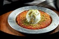 Appetizing Turkish sweetness Kanafeh made with shredded filo pastry with honey, pistachios and white ice cream