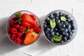 Appetizing variety of forest fruits strawberries, large strawberries, raspberries, blueberries, red berries in a glass bowl and Royalty Free Stock Photo