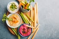 Fresh vegetarian dips in small bowls on table