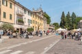 People visiting central square of the ancient village Appiano Gentile, province of Como, Italy