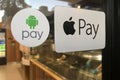 Apple and Android Pay Stickers on a Door