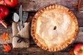 Apple autumn pie, overhead table scene over rustic wood