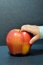 Apple with babies hand Royalty Free Stock Photo