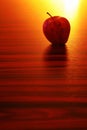 Apple in the backlight. Fruit on the rustic wooden table. Royalty Free Stock Photo