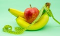 Apple and banana with measuring tape Royalty Free Stock Photo