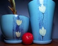 An apple and blue flower pots Royalty Free Stock Photo