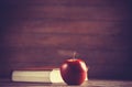 Apple and the book. Royalty Free Stock Photo