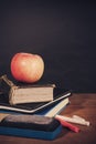 Apple, Books and Chalks with Blackboard Background Royalty Free Stock Photo