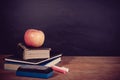 Apple, Books and Chalks with Blackboard Background Royalty Free Stock Photo