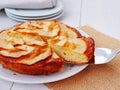 Apple cake on white plate with one slice on a cake server Royalty Free Stock Photo