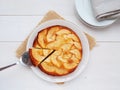 Apple cake on white plate with one slice on a cake server Royalty Free Stock Photo