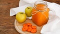 Apple and carrot juice in glass, fresh vegetables and fruits on wooden Royalty Free Stock Photo