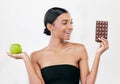 Apple, chocolate and woman with healthy food choice or offer isolated on studio, white background for sugar and diet Royalty Free Stock Photo