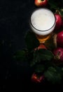 Apple cider in beer glass with fresh apples, black background, t Royalty Free Stock Photo