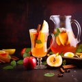 Apple cider cocktail with red oranges and spices in glasses and jug on table