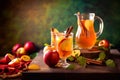 Apple cider cocktail with red oranges and spices in glasses and jug on table