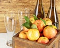 Bottles with cider, glasses and organic apples in a wooden box Royalty Free Stock Photo